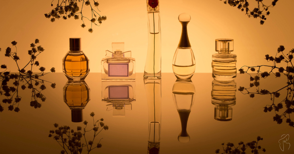 A group of perfume bottles in various shapes and sizes sitting on a table