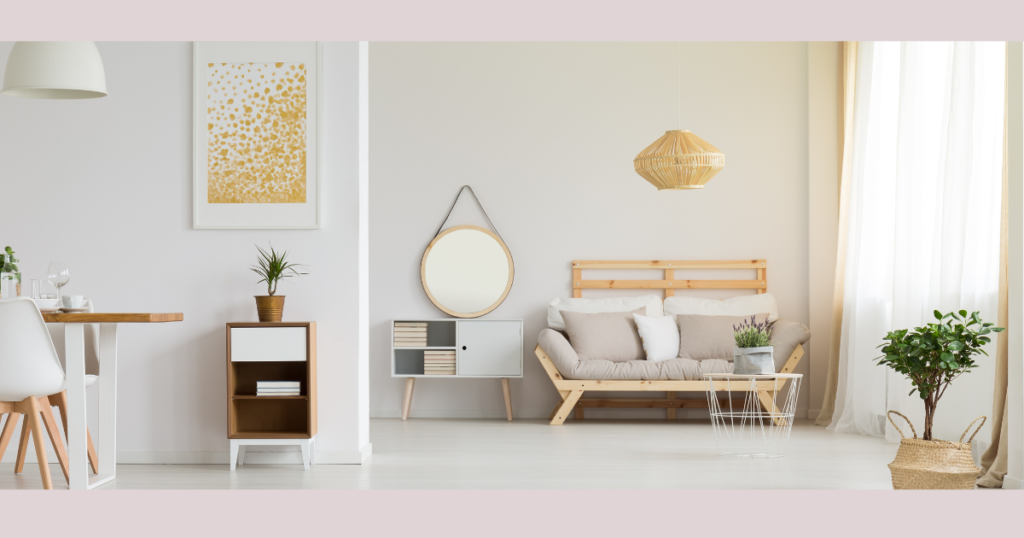  a living room with a couch, a coffee table, a mirror, and a plant.