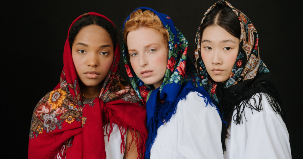 Three women wearing colorful headscarfs 