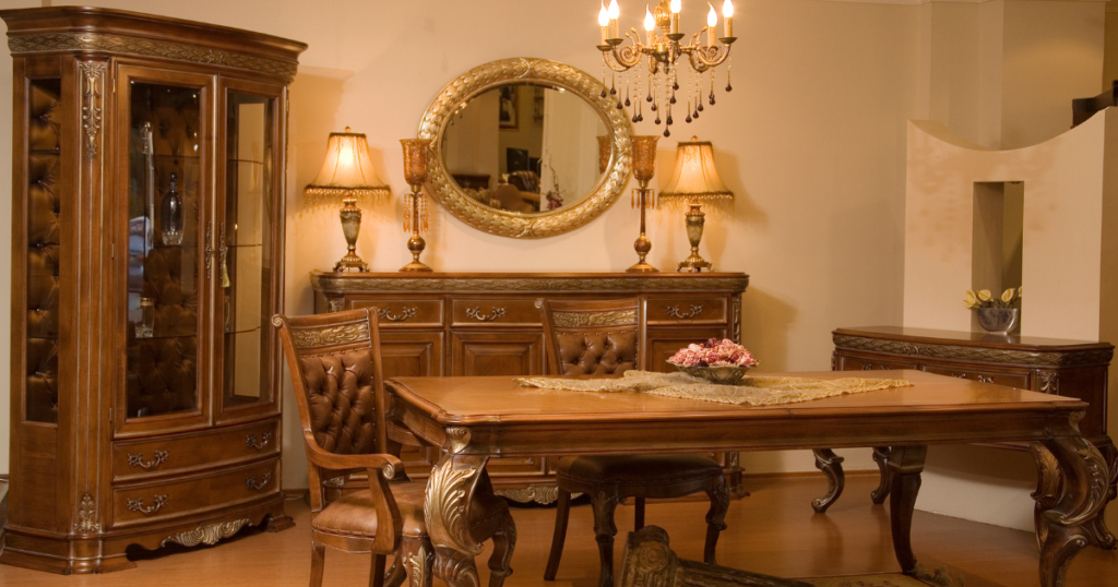 a dining room with a rectangular wooden table and chairs with high backs.
